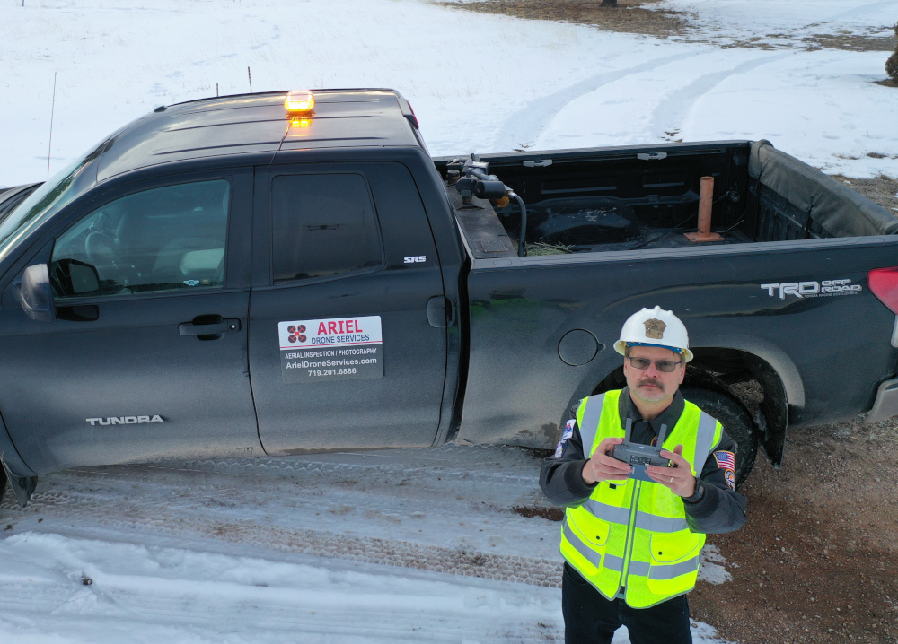 Drone Pilot in front of Ariel Drone Services truck